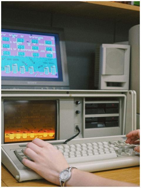 Close-up of hands interacting with a retro compute