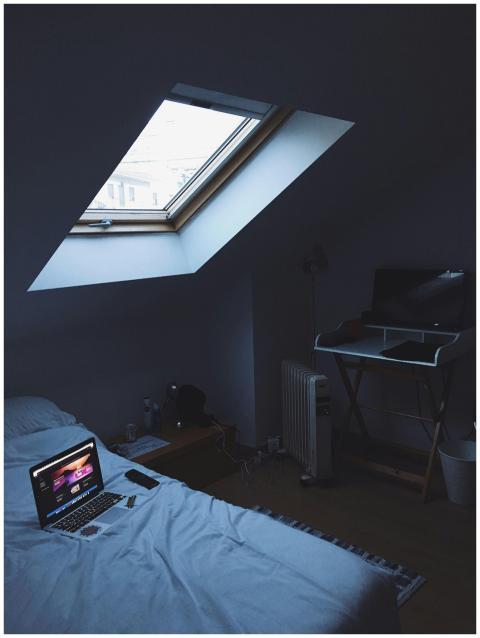A modern home office setup in a cozy attic bedroom