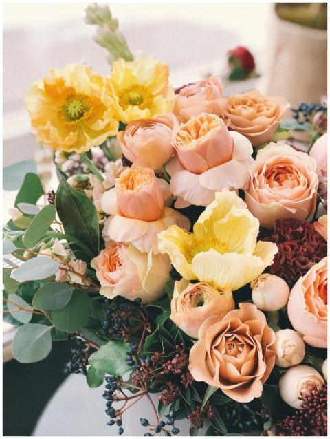 A beautiful floral bouquet featuring roses and pop