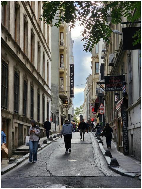 A lively street scene in Istanbul, featuring pedes