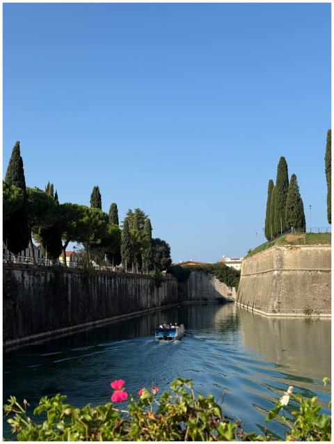 Picturesque canal view in Italy with a boat surrou