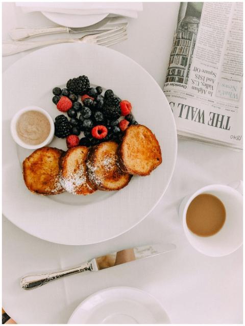 Chic breakfast setup with toast, mixed berries, co