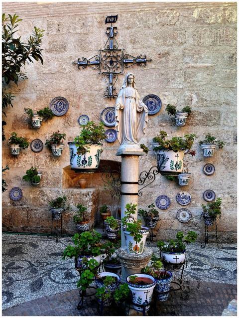 A peaceful courtyard featuring a religious statue