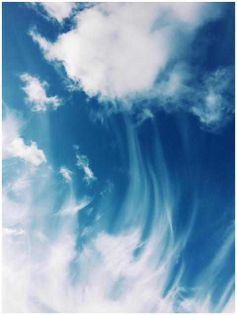 Serene cloud formations against a bright blue sky,