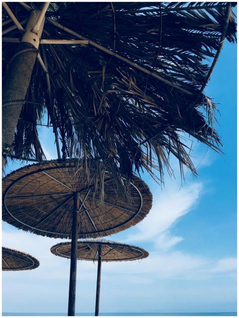 Capture of straw umbrellas on a sunny day at Skala
