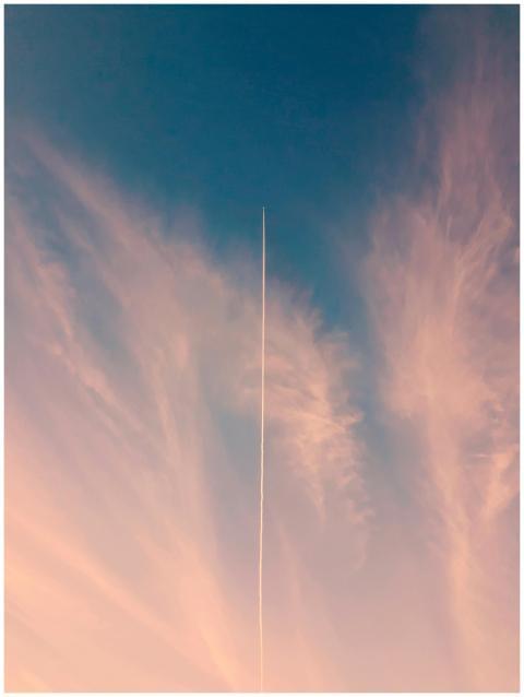 A scenic view of a dramatic sky with a single cont