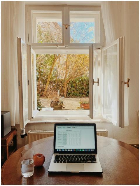 Cozy home office setup with laptop on desk facing