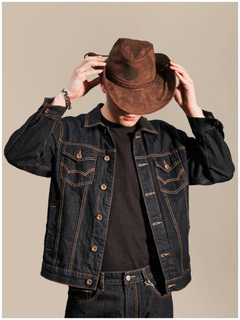 A man in denim and a cowboy hat presents a stylish