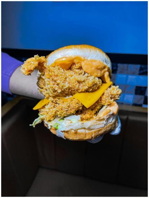 Close-up of a crispy chicken burger with cheddar,