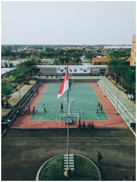 Aerial view of students playing basketball on an o