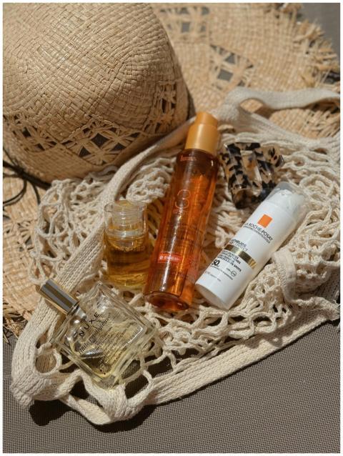 Stylish flat lay of beach bag essentials including