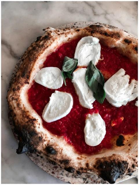 Delicious Margherita pizza with fresh basil, melte