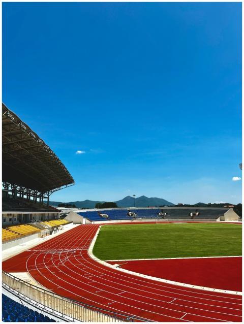 Spacious outdoor stadium with vibrant running trac