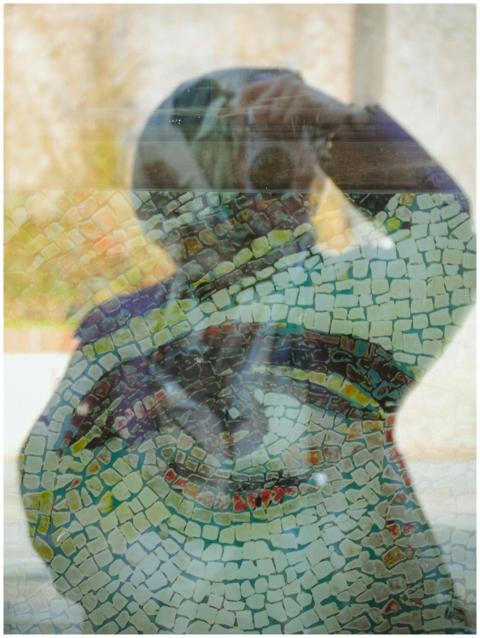 A captivating photo of a person's reflection on gl