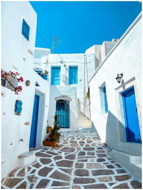 Explore a scenic Greek alley featuring blue doors