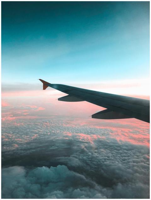 Dramatic view of an airplane wing over a colorful