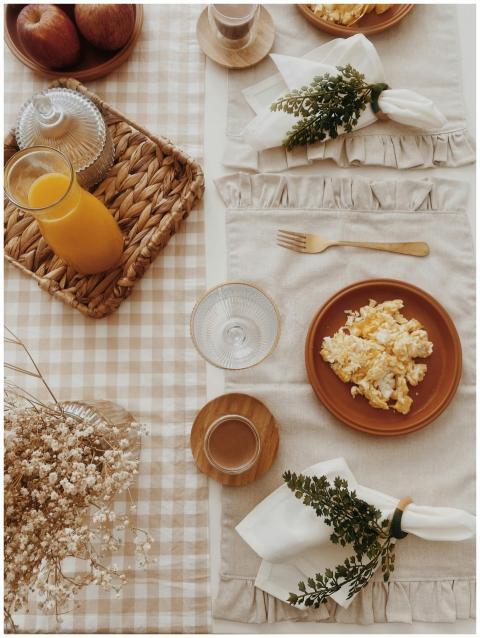 A cozy breakfast setup with scrambled eggs, orange