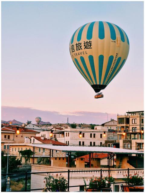 A vibrant hot air balloon soars over Cappadocia's