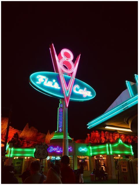 Vibrant neon signs illuminate a vintage-style dine