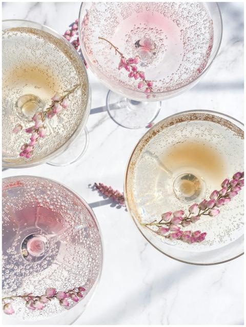 A top view of sparkling cocktails with floral garn