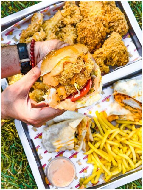 Enjoying a fast food feast outdoors with fried chi