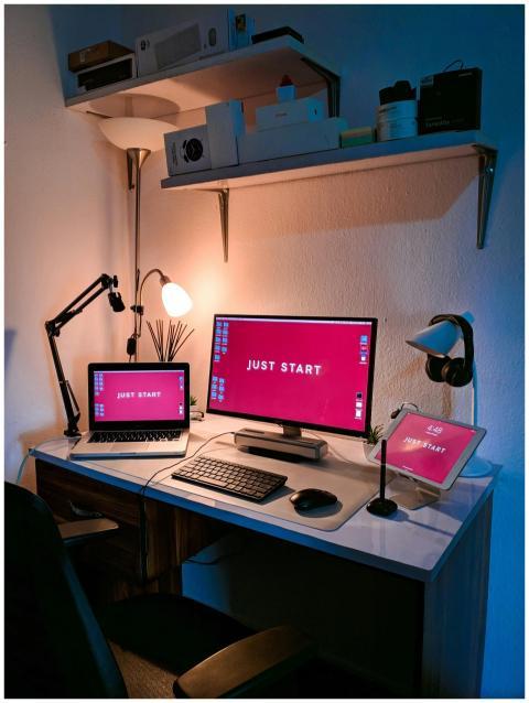 A stylish home office setup featuring a laptop, mo