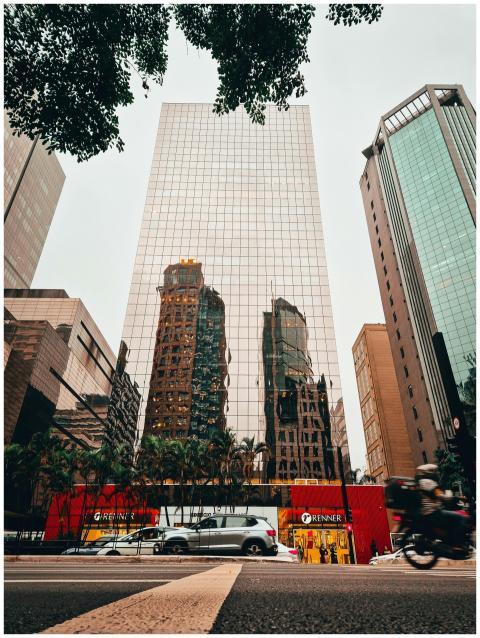 High-rise buildings reflecting in glass facade on