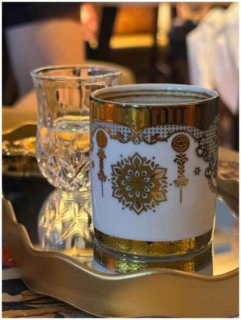Intricate Turkish coffee cup with gold detail next