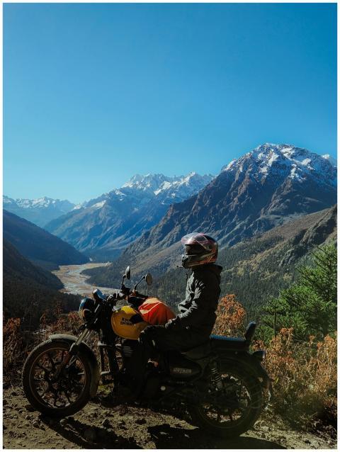 Motorcyclist Admiring Majestic Mountain