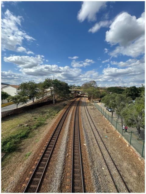 Aerial view of railway tracks surrounded by greene