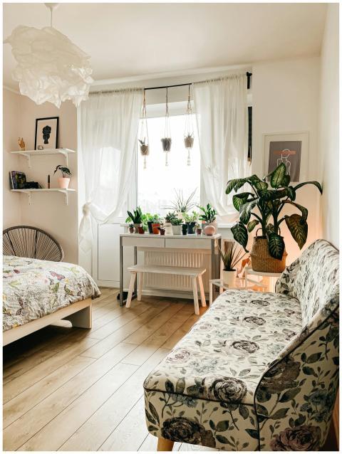 A bright and airy Scandinavian-style bedroom featu