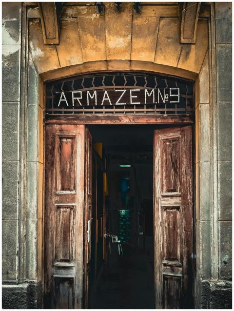 Explore a rustic wooden doorway leading to Armazem