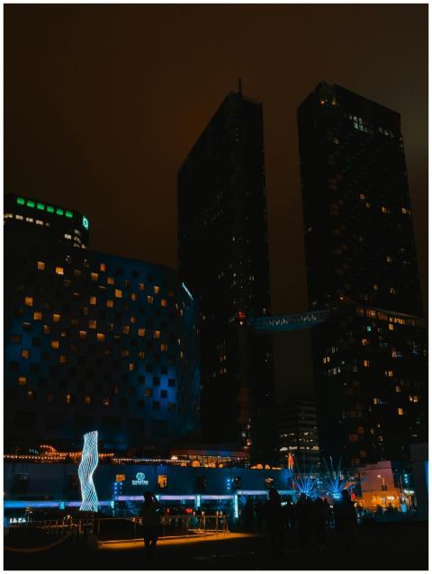 A dramatic view of modern skyscrapers illuminated