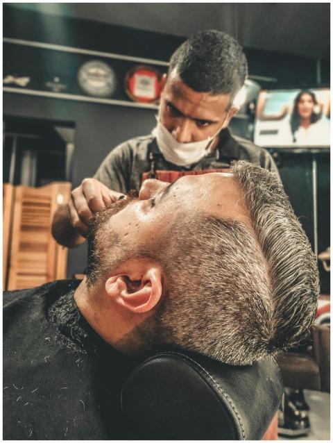 A barber skillfully provides a haircut and groomin