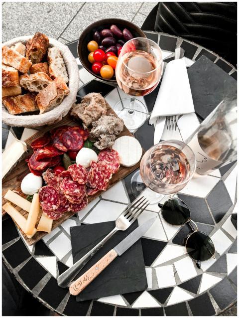 A gourmet charcuterie board with cheeses, meats, b