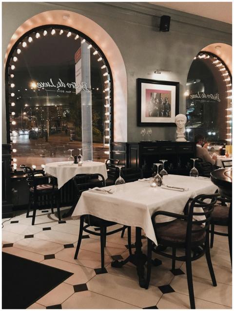 Elegant restaurant interior with tables set for fi