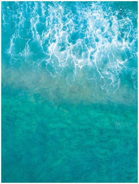 A stunning aerial view of turquoise ocean waves cr