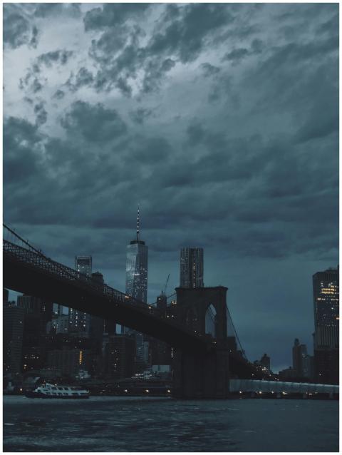A dramatic view of the Brooklyn Bridge and New Yor