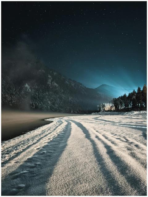 Captivating winter night view of a snowy valley an