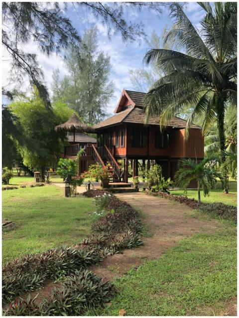 Charming traditional Thai wooden house surrounded