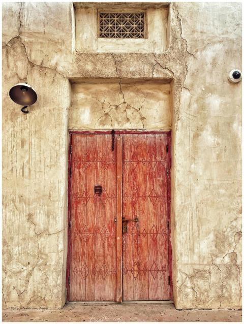 Rustic wooden door set in an old wall with distres