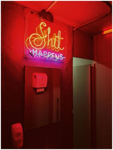 Neon sign with humorous text, glowing in a subdued