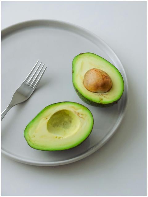 High-quality image of fresh avocado halves on a wh