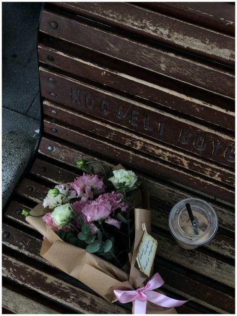 A bouquet of flowers with iced coffee on a vintage