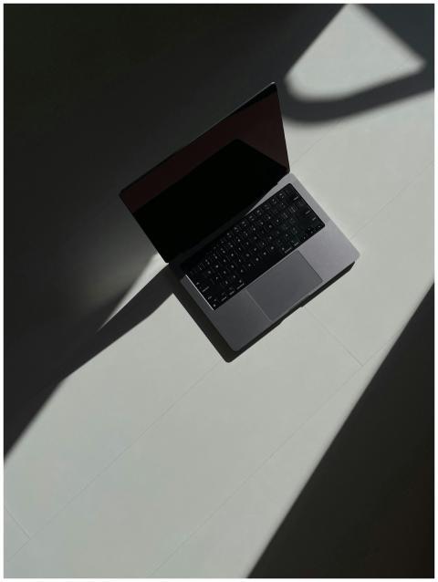 Artistic overhead view of an open laptop casting s