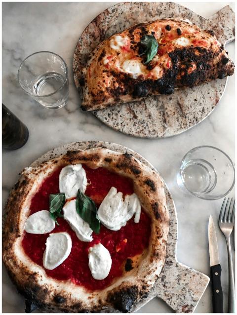 Close-up of artisan Neapolitan pizzas with fresh m