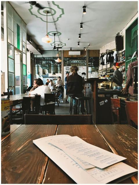 Cozy coffee shop interior with people dining and a