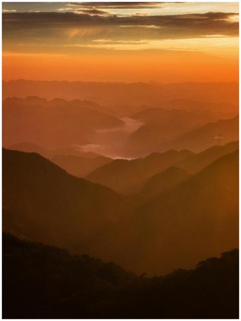 A breathtaking view of mountains under a vibrant s