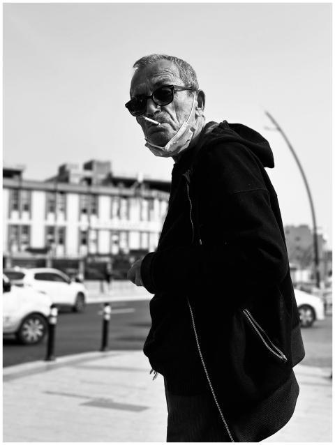 Black and white portrait of an elderly man smoking