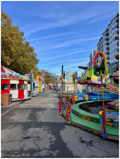 Colorful amusement park rides and food stalls unde